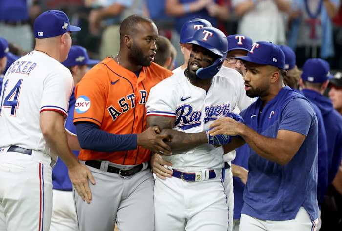 Oct 20, 2023; Arlington, Texas, USA; Texas Rangers right fielder Adolis Garcia (53) is held back by Houston Astros left fielder Yordan Alvarez (44) after being hit by a pitch during the eighth inning of game five in the ALCS for the 2023 MLB playoffs at Globe Life Field. Mandatory Credit: Kevin Jairaj-USA TODAY Sports